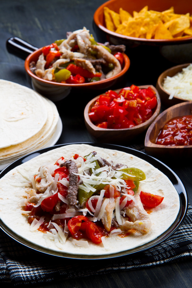 Chicken And Beef Fajitas
 Beef and chicken fajitas with colorful bell peppers in